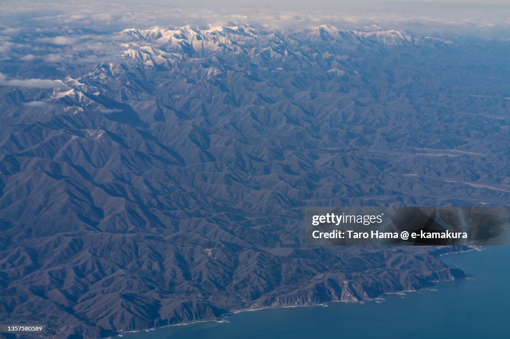 Snowcapped Hidaka Mountains in Hokkaido of Japan aerial view from airplane