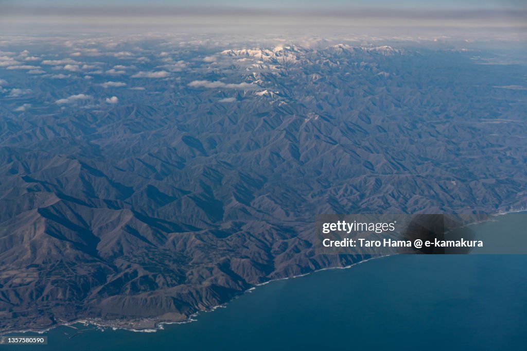 Snowcapped Hidaka Mountains in Hokkaido of Japan aerial view from airplane
