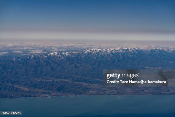snowcapped hidaka mountains in hokkaido of japan aerial view from airplane - hidaka mountains stock pictures, royalty-free photos & images