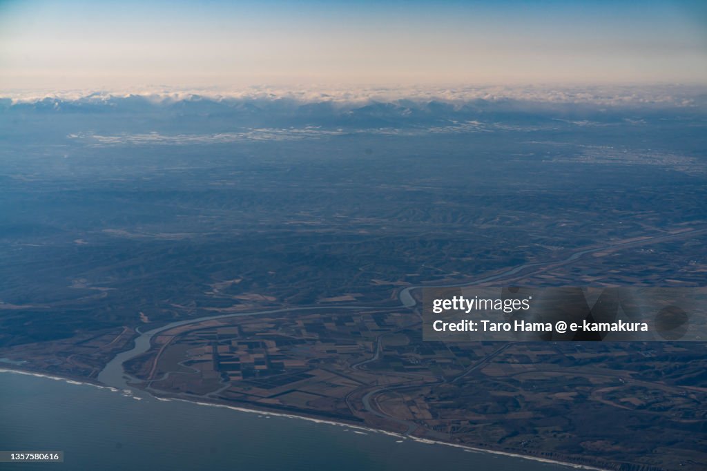 Snowcapped Hidaka Mountains in Hokkaido of Japan aerial view from airplane