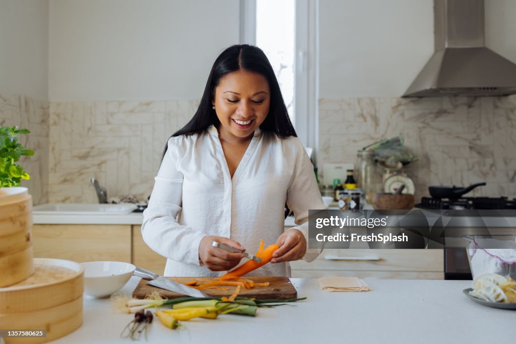 Smiling Woman Preparing Healthy Meal in her Kitchen
