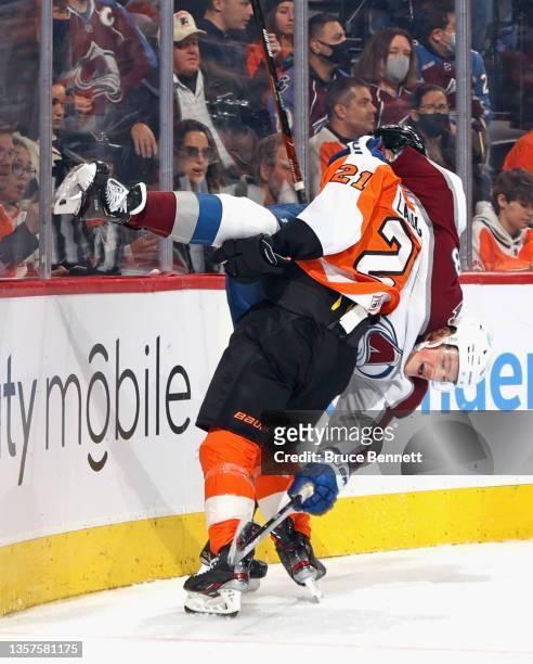 Scott Laughton of the Philadelphia Flyers flips Cale Makar of the Colorado Avalanche during the second period at the Wells Fargo Center on December...