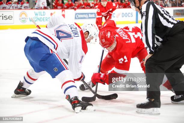 Dylan Larkin of the Detroit Red Wings faces off against Nick Suzuki of the Montreal Canadiens during an NHL game at Little Caesars Arena on November...