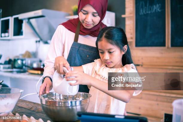 cute child with mother using mixer machine - mixer stock pictures, royalty-free photos & images