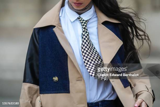 Gabriella Berdugo wears a brown ribbed wool turtleneck pullover, a white shirt from Wrangler, a black and white checkered tie form Courrèges, navy...