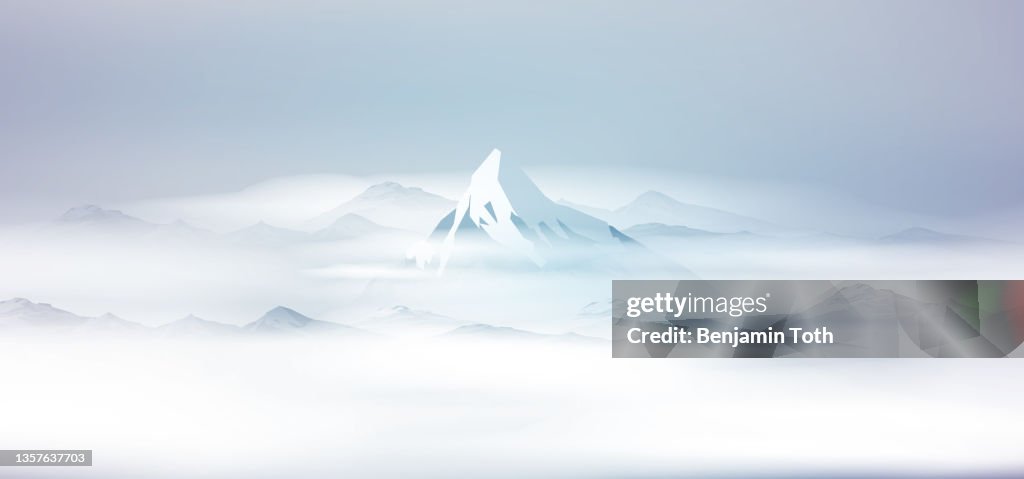 Sunrise in snow covered mountains landscape with fog
