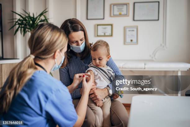 little boy getting vaccinated - vaccination imagens e fotografias de stock