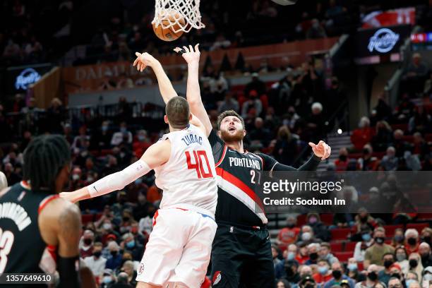 Ivica Zubac of the Los Angeles Clippers blocks a shot by Jusuf Nurkic of the Portland Trail Blazers during the first half at Moda Center on December...