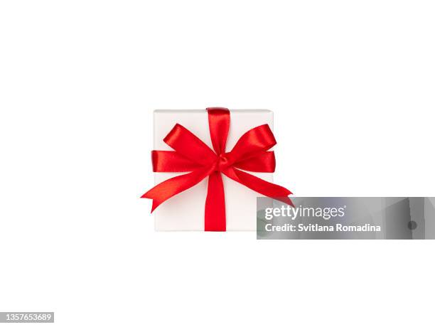 white gift box with red ribbon, bow tied, isolated on white background - tied knot stock pictures, royalty-free photos & images