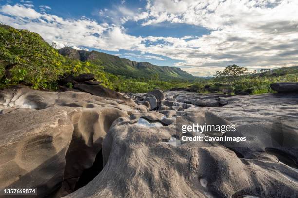 river running among rocks in vale da lua moon valley, chapada dos veadeiros, goias, brazil - chapada dos veadeiros stock-fotos und bilder