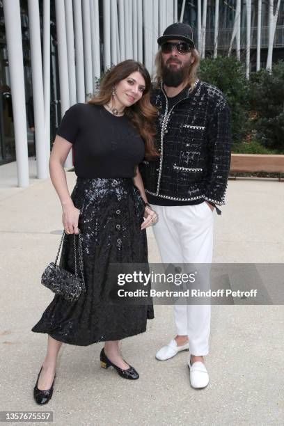 Amandine de la Richardiere and Sebastien Tellier attend the Chanel Metiers D'Art 2021-2022 show at Le 19M on December 07, 2021 in Paris, France.