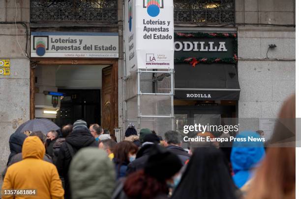 Several people queue at a lottery office in central Madrid with less than three weeks to go until the Extraordinary Christmas Lottery Draw on...