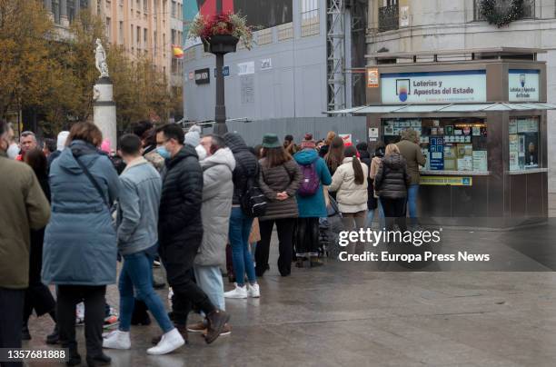 Several people queue at a lottery office in central Madrid with less than three weeks to go until the Extraordinary Christmas Lottery Draw on...