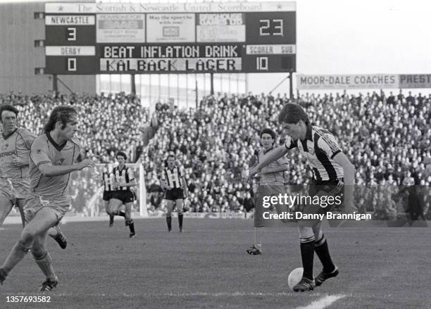 The electronic scoreboard reads "Beat Inflation, Drink Kalback Lager" as Newcastle winger Chris Waddle runs at Derby player Steve Powell during a 3-0...