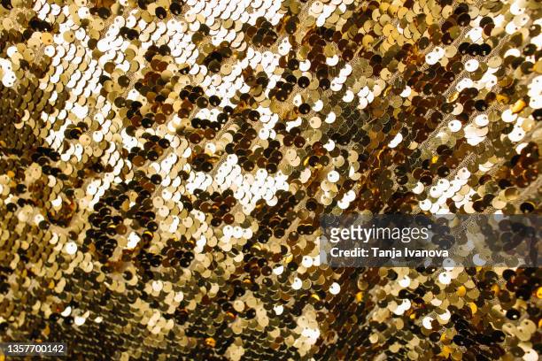 gold textile fabric with shiny sequins as background - sequin stock pictures, royalty-free photos & images