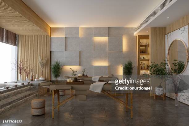 intérieur de la salle de massage spa de luxe avec tables de massage, bain à remous et sol en marbre. - banc de massage photos et images de collection