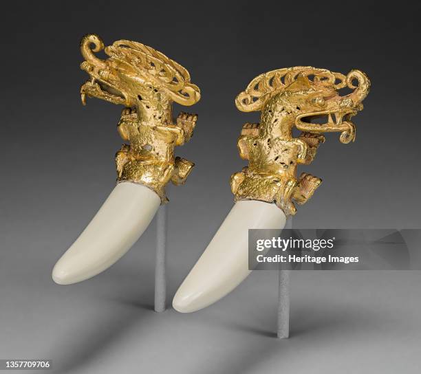 Double Pendant in the Form of a Mythical Saurian with Tusks, A.D. 800/1200. Gold caiman-like creatures, with plaster restoration of boar tusks....