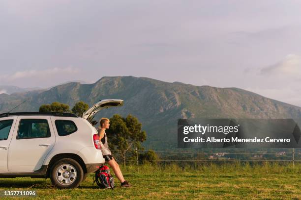 young woman traveler sitting in the trunk - wilderness camping stock pictures, royalty-free photos & images