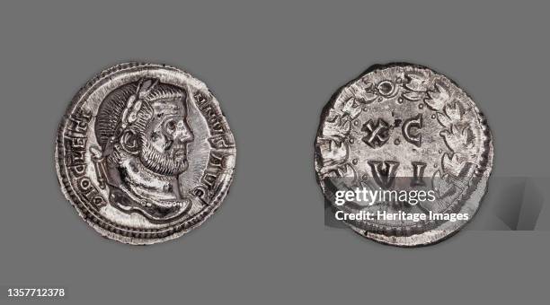 Argenteus Portraying Emperor Diocletian issued by Diocletian or Maximianus. Reverse: laurel wreath and inscription. X C V I, referring to the...