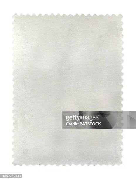 close-up of a blank white stamp isolated on white. - sello postal fotografías e imágenes de stock