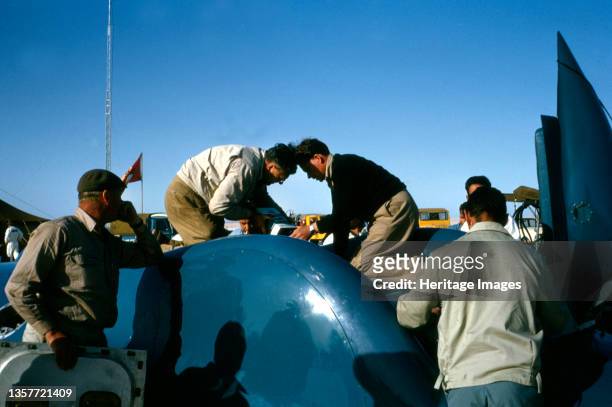 Mechanics working on Bluebird CN7 for World Land speed record attempt, Lake Eyre, Australia, 1964. Artist Unknown.