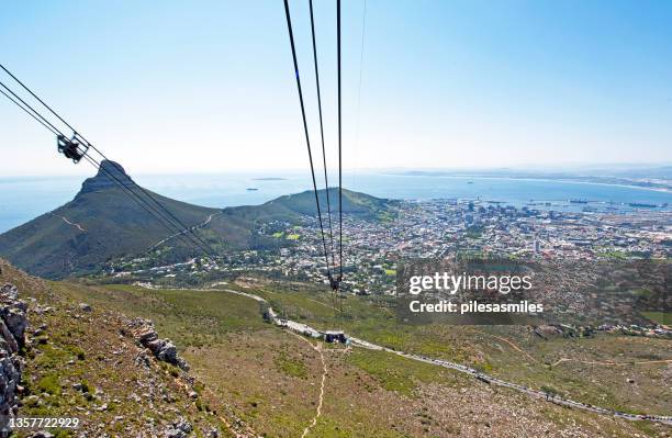 view of cable car and lions head from table mountain, cape town,, cape province, south africa. - cape town cable car stock pictures, royalty-free photos & images