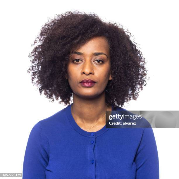 studio portrait on white of a woman person of color with afro hair - african american woman serious stock pictures, royalty-free photos & images