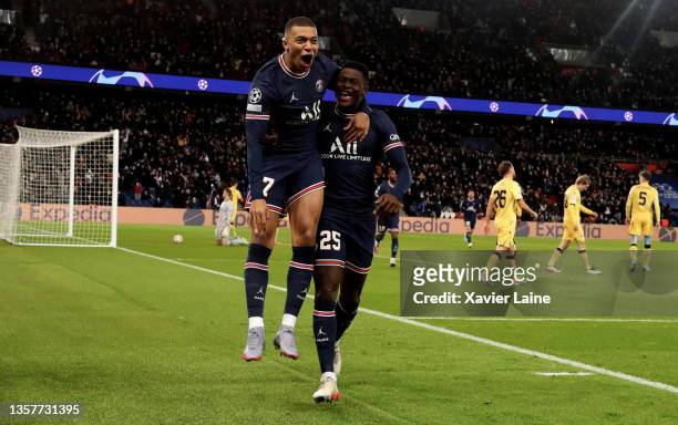 Kylian Mbappe of Paris Saint-Germain celebrates his first goal with Nuno Mendes during the UEFA Champions League group A match between Paris...