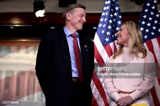 Rep. Marjorie Taylor Greene smiles at Rep. Paul Gosar during a news conference at the U.S. Capitol Building on December 07, 2021 in Washington, DC....