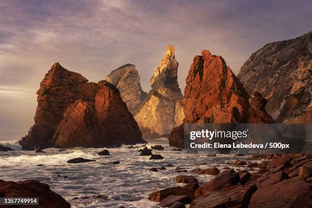 charmed with the rocks,panoramic view of rocks on beach against sky - portugal sintra stock-fotos und bilder