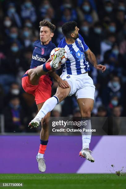 Mehdi Taremi of FC Porto is challenged by Marcos Llorente of Atletico Madrid during the UEFA Champions League group B match between FC Porto and...