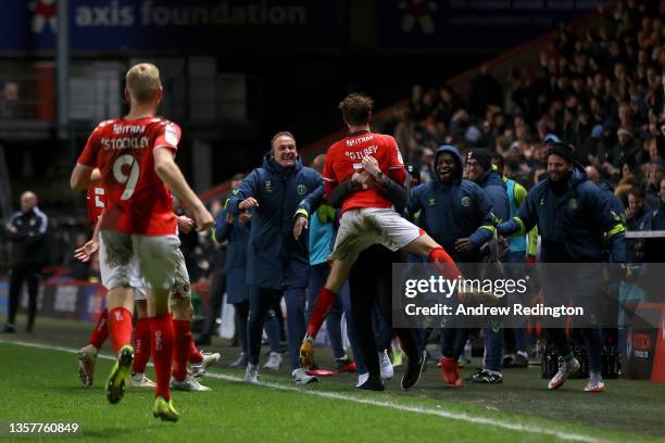 Alex Gilbey of Charlton Athletic celebrates with the coaching team after scoring their side's second goal during the Sky Bet League One match between...