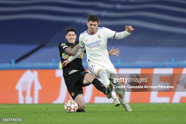 Alessandro Bastoni FC Internazionale Milano tackles Luka Jovic of Real Madrid CF during the UEFA Champions League group D match between Real Madrid...