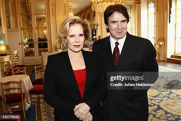 Sylvie Vartan poses with her husband Tony Scotti before being awarded Commandeur des Arts et Lettres at Ministere de la Culture on December 14, 2011...