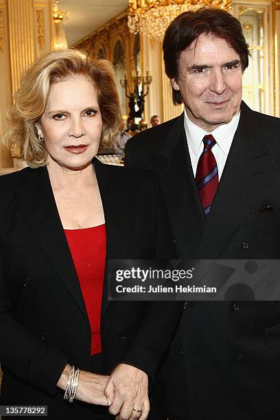 Sylvie Vartan poses with her husband Tony Scotti before being awarded Commandeur des Arts et Lettres at Ministere de la Culture on December 14, 2011...