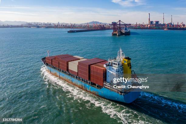 drone point view of a large cargo ship in front of qianwan port, qingdao city, shandong province, china - qingdao beach stock pictures, royalty-free photos & images