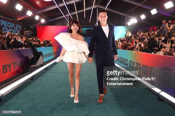 Pictured: Sarah Hyland and Wells Adams arrive to the 2021 People's Choice Awards held at Barker Hangar on December 7, 2021 in Santa Monica,...