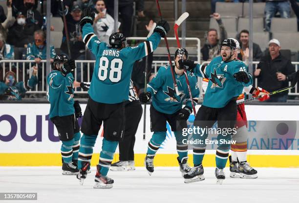 Tomas Hertl of the San Jose Sharks is congratulated by Brent Burns after he scored in the first period against the Calgary Flames at SAP Center on...