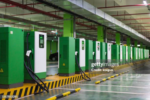 green energy utilization, fast charging stations for urban electric vehicles - stromtankstelle stock-fotos und bilder