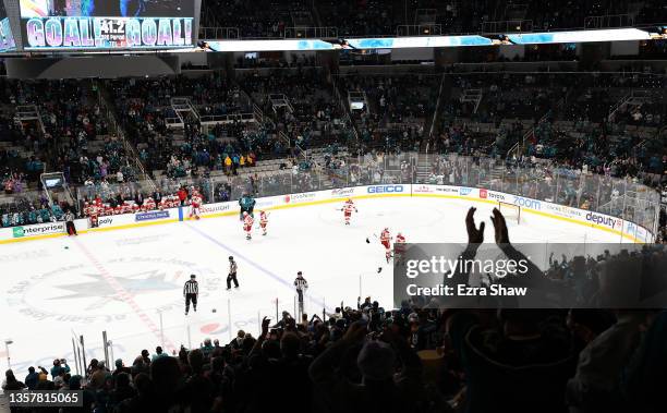 Fans celebrate after Tomas Hertl of the San Jose Sharks scored a hat trick against the Calgary Flames in the third period at SAP Center on December...