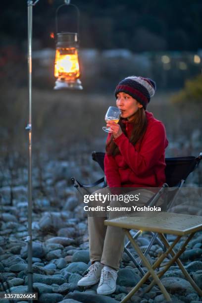 a group enjoying camping on a riverbank in the suburbs - camping lantern stock pictures, royalty-free photos & images