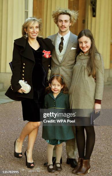 Sam Taylor-Wood wears her OBE with partner Aaron Johnson and her children Angelica and Jessie after it was presented to her by Prince Charles, Prince...