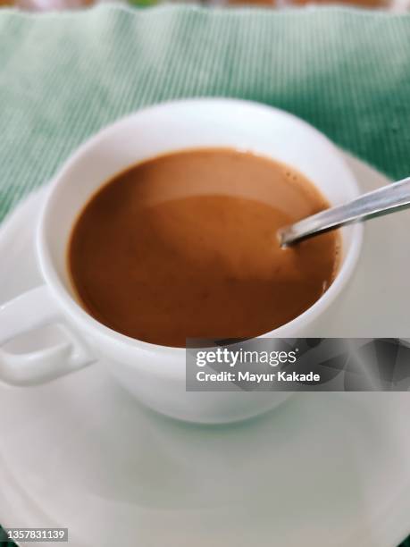 cup  filled with tea and a stirring spoon - stirring stock pictures, royalty-free photos & images