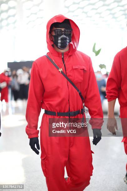 Singer and actor Jiro Wang dressed as character of series 'Squid Game' is seen at Shenzhen Baoan International Airport on December 8, 2021 in...