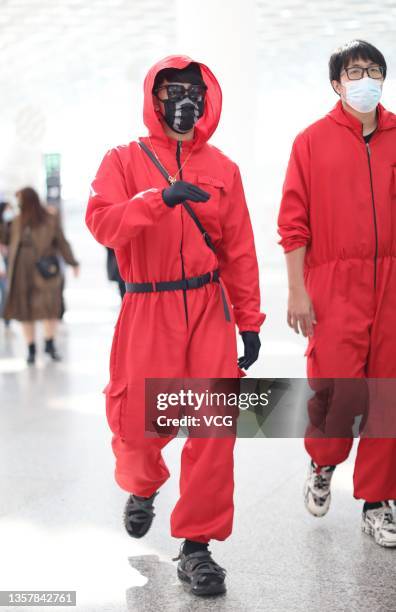 Singer and actor Jiro Wang dressed as character of series 'Squid Game' is seen at Shenzhen Baoan International Airport on December 8, 2021 in...