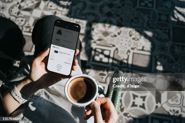 personal perspective of young woman relaxing in sidewalk cafe, shopping online with smartphone and making mobile payment with credit card. lifestyle and technology. convenience and simple online shopping experience - shopping screen stock-fotos und bilder