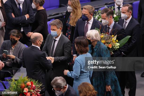 New German Chancellor Olaf Scholz receives congratulations from colleagues, including Robert Habeck of the Greens Party, who will be Vice Chancellor,...