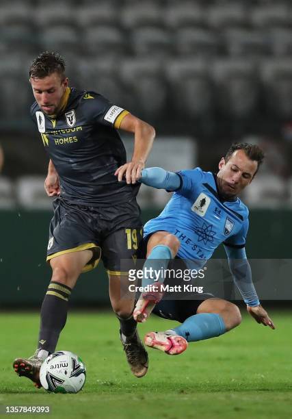 Michael Ruhs of Macarthur FC is challenged by Adam Le Fondre of Sydney FC during the FFA Cup round of 16 match between Sydney FC and Macarthur FC at...