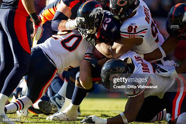 Willis McGahee of the Denver Broncos is gang tackled by the Chicago Bears at Sports Authority Field at Mile High on December 11, 2011 in Denver,...