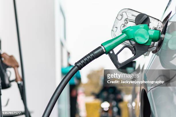 hand refilling the car with fuel, close-up. - luftpump bildbanksfoton och bilder